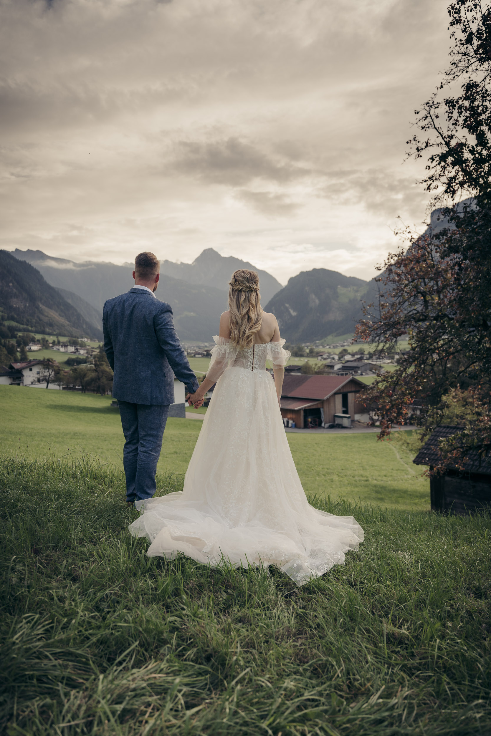 Authentic bride and groom portrait in the Zillertal Alps, featuring earthy tones and a grainy analog aesthetic - Alpenglow Visuals.